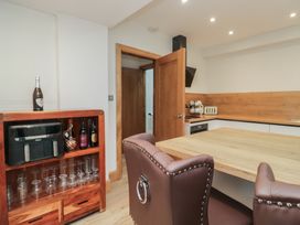A kitchen with a table and bar cabinet at Park View in Ambleside
