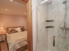 A bedroom with a bed and shower at Park View in Ambleside
