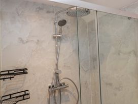 A shower area with showerhead and glass panel at Park View in Ambleside