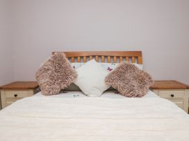 A bed with pillows and bedside tables at Park View in Ambleside