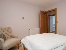 A bedroom with an armchair and a bed at Park View in Ambleside
