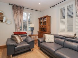 A living room with sofas and a bookshelf at Park View in Ambleside
