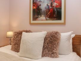 A bedroom with pillows and a painting at Park View in Ambleside