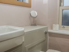 A bathroom with a sink, toilet, and mirror at Park View in Ambleside