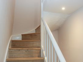 A staircase with wooden steps and white handrail at Park View in Ambleside