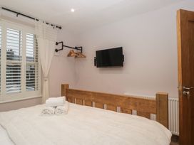 A bedroom with a bed and television at Park View in Ambleside