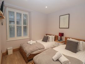 A bedroom with two single beds and a television at Park View in Ambleside