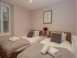 A bedroom with two beds and a window at Park View in Ambleside