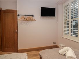 A bedroom with a television and hangers at Park View in Ambleside