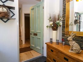 A hallway with a door and a mirror at Park View in Ambleside