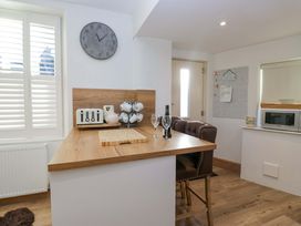 A kitchen with a countertop and bar stools at Park View in Ambleside