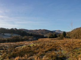 A landscape with grass, river and hills at Park View Ambleside
