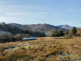 A view of a lake surrounded by trees and mountains at Park View in Ambleside
