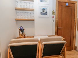 A dining room with wine glasses and a table at Park View Ambleside