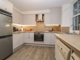 A kitchen with cabinets and appliances at The Burrow in Windermere