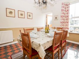 A dining room with a table set for dinner at The Burrow in Windermere