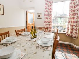 A dining room with a table set for meals at The Burrow in Windermere