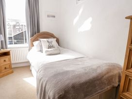 A bedroom with a single bed and a bedside table at The Burrow in Windermere