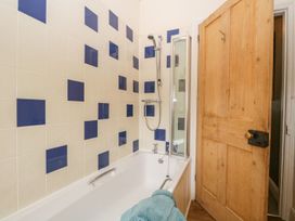 A bathroom with a bathtub and shower at The Burrow in Windermere