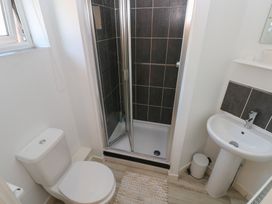 A bathroom with a shower, toilet, and sink at 9 Ffordd Donaldson Swansea