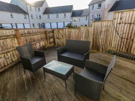 An outdoor seating area with chairs and a table at 9 Ffordd Donaldson Swansea