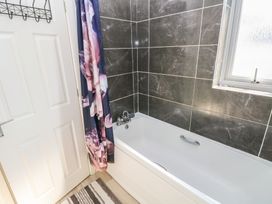 A bathroom with a bath tub and shower curtain at Swansea Escape in Swansea
