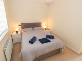 A bedroom with a bed and nightstands at Swansea Escape in Swansea