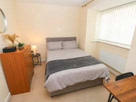 A bedroom with a bed and bedside table at Swansea Escape, Swansea