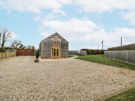 An outdoor area with a house and table at Cedar Barn in 