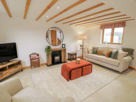 A living room with a sofa and coffee table at Cedar Barn