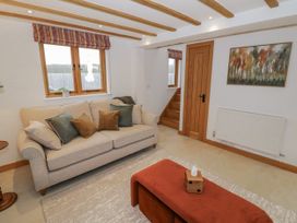 A living room with a sofa and coffee table at Cedar Barn