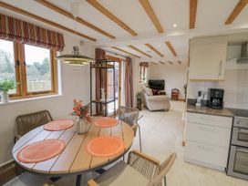 A dining room with a table and chairs at Cedar Barn