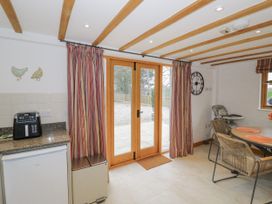 A kitchen with a table and chairs at Cedar Barn
