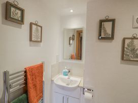 A bathroom with a sink and towel rack at Cedar Barn