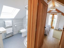 A bathroom with a shower and a toilet at Cedar Barn 
