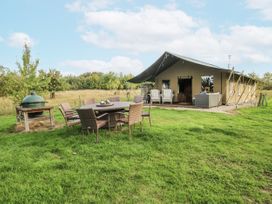 A tent with a dining set and barbecue grill at Pear Trees in Bewdley