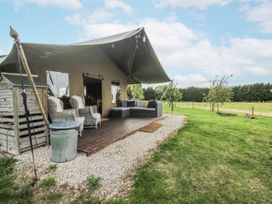 An outdoor seating area with a tent and sofa at Pear Trees in Bewdley