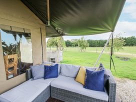 A sofa with cushions in an outdoor seating area at Pear Trees Bewdley