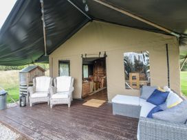 An outdoor seating area with chairs and a couch at Pear Trees in Bewdley