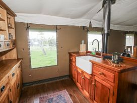 A kitchen with a sink and wooden cabinets at Pear Trees in Bewdley
