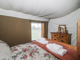 A bedroom with a bed and dresser at Pear Trees in Bewdley