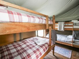 A bedroom with bunk beds and linens at Pear Trees in Bewdley