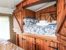 A bedroom with a lofted bed and towels at Pear Trees in Bewdley