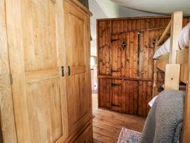 A bedroom with a wardrobe and bunk bed at Pear Trees Bewdley