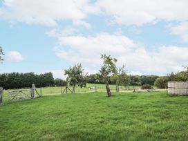 An outdoor scene with a gate and trees at Pear Trees in Bewdley