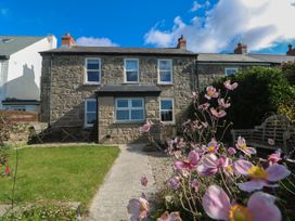 A house with flowers and benches at 12 Boswedden Terrace St Just
