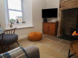 A living room with a fireplace and television at 12 Boswedden Terrace St Just