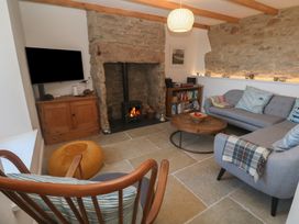 A living room with a sofa and armchair at 12 Boswedden Terrace St Just