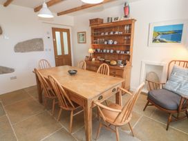A dining room with a wooden table and chairs at 12 Boswedden Terrace St Just