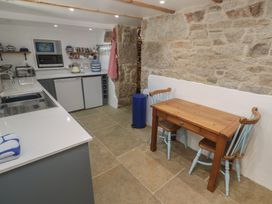 A kitchen with a sink and table at 12 Boswedden Terrace in St Just